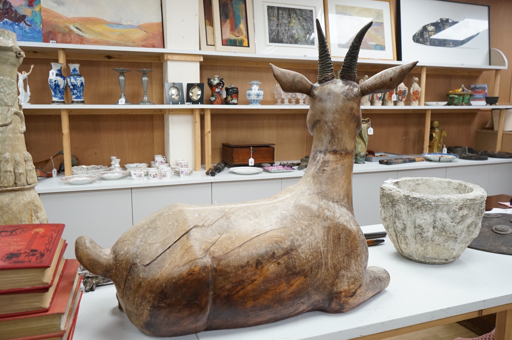 A large Vietnamese hardwood model of a recumbent goat, 78cm wide